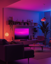 A living room bathed in vibrant magenta and blue hues, featuring modern furniture, a large TV with a dynamic screen saver, and a neatly arranged shelf, creating an immersive atmosphere. A living room bathed in vibrant magenta and blue hues, featuring modern furniture, a large TV with a dynamic screen saver, and a neatly arranged shelf, creating an immersive atmosphere.