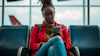 woman of color sitting at the gate waiting for her flight woman of color sitting at the gate waiting for her flight